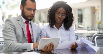 focused-coworkers-checking-reports